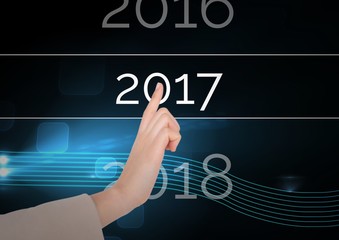 Hand touching 2017 in digitally generated background