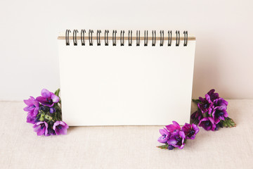 Notepad and Purple flowers, toning copy space background