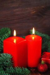 Burning candles with christmas decorations