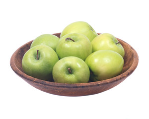 Green organic granny smith apples in wooden bowl isolated on white background