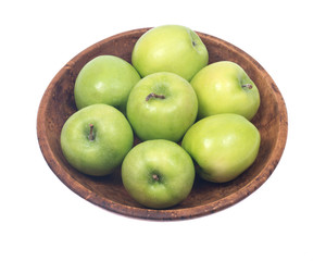 Green organic granny smith apples in wooden bowl isolated on white background