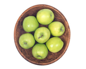 Green organic granny smith apples in wooden bowl isolated on white background