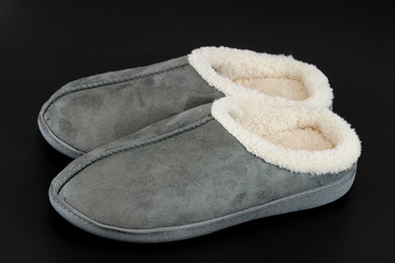 winter slippers isolated on black background