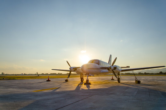 Fototapeta Small Airplane or Aeroplane Parked at Airport.Small Airplane Famous to use Private Airplane.Sunset Light and Mountain View.