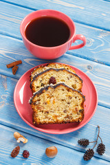 Cup of coffee and fresh baked fruitcake on boards
