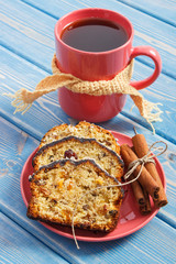 Cup of tea, fresh baked fruitcake on plate