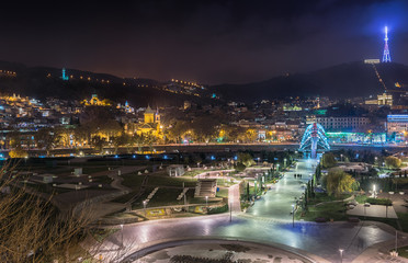 Fototapeta na wymiar Georgia, Tbilisi, November 23, 2016. Night view on the Rike Park, European square, TV tower and the pedestrian Bridge of Peace