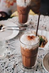 Glass of Cold Iced Mocha Coffee in the Coffee shop, Vintage tone