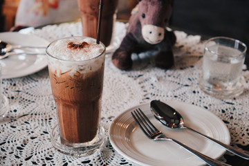 Fototapeta na wymiar Glass of Cold Iced Mocha Coffee in the Coffee shop, Vintage tone