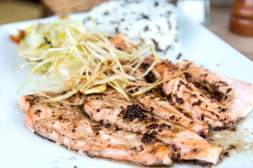 grilled salmon and lemon - french cuisine dish with tomato and s