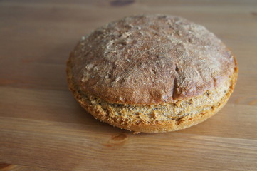 Round bread on wooden surface 
