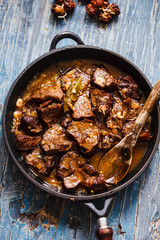 Beef stewed cast iron. Meat Stew of beef with caramelized onion. Overhead of Roasted beef meat. 