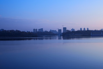 Morning on the Dnieper River. View of the right bank. You can see the high-rise buildings on the horizon
