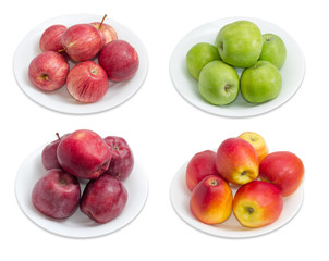 Four cultivars of apples on white dishes on light background