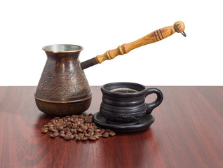 Old coffee pot, black ceramic cup with coffee, coffee beans
