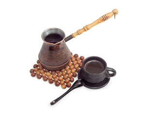 Turkish coffee in copper coffee pot and black ceramic cup