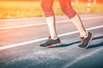 Fitness Girl Runner on track. Urban jogger Getting ready to start