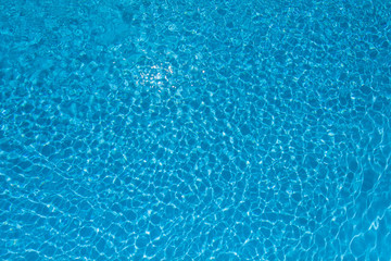Fototapeta na wymiar Beautiful ripple water surface with sun reflection in swimming p