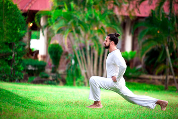 Man doing yoga in tropic jungle