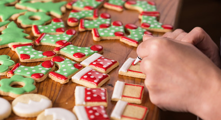 woman decorating gingerbread christmas cookies