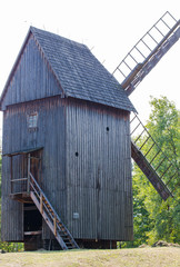Fototapeta na wymiar Old vintage windmill in a village