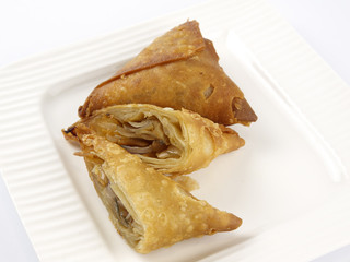 onion puffs served in a white plate on white background