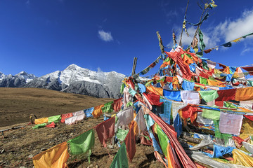 Lijiang, China - November 11, 2016: Tibetan Prayer Flags on foreground and Jade Dragon Snow Mountain on background