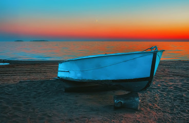 Blue Boat On The Beach At Sunset