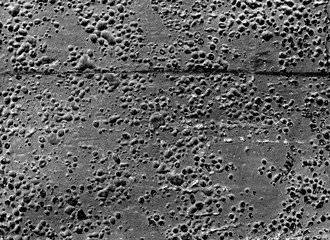 Grungy black and white rubber surface with bubbles and scratches