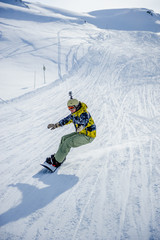 Fototapeta na wymiar Snowboarder riding at French Alps mountain slopes