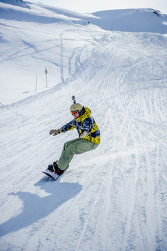 Snowboarder riding at French Alps mountain slopes