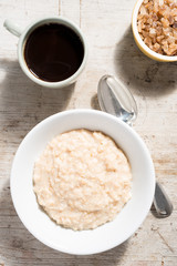 Porridge, Coffee and Sugar Bowl on Wooden Background