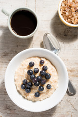 Blueberry Oatmeal, Coffee and Sugar Bowl on Wooden Background