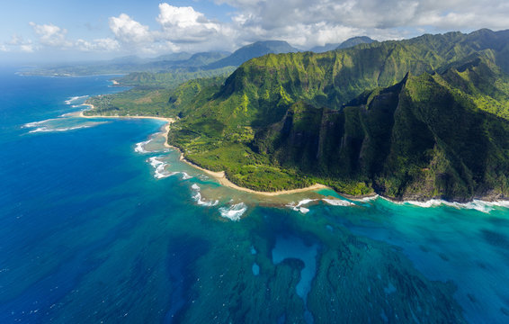 View on the mountains of Kauai's north coast with Kee Beach and the reef from Kailio Point. Aerial shot from a helicopter, Kauai, Hawaii.