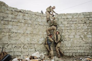 rangers team climbing from a wall