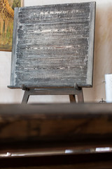 Focus on black chalk board in old classroom