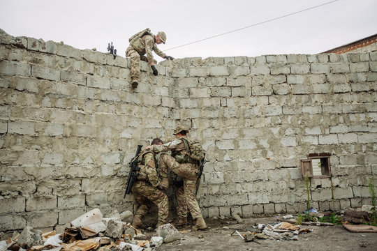 rangers team climbing from a wall