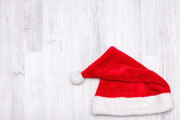 Obraz na płótnie Canvas Santa Claus hat on wooden background.