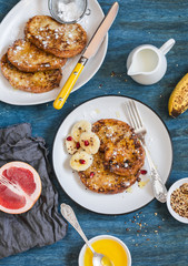 Breakfast - caramel cinnamon french toast with a banana. On a blue background, top view