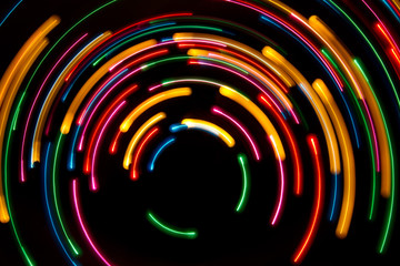 Colorful light trails on dark background. Light painting in circular shape
