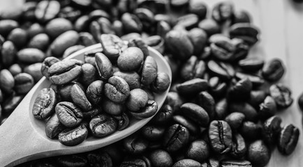 Coffee beans whit wooden spoon on wood.. , black and white