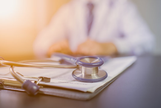 Medicine doctor's working table. Focus on stethoscope
