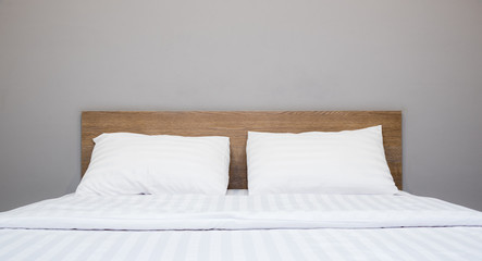 white bedding and pillow in hotel room