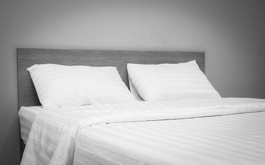 white bedding and pillow in hotel room ,  black and white