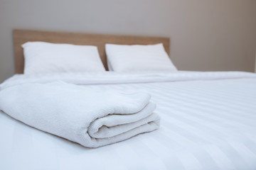 Fototapeta na wymiar Close up white towels lying on the bed