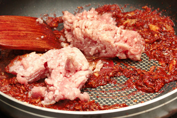 Cooking spicy meat and tomato dip. Selective focus