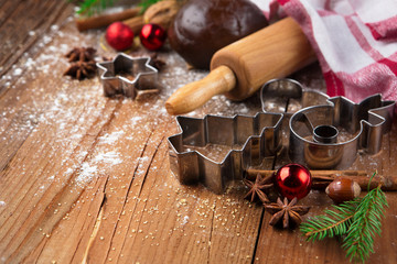 Christmas baking background with gingerbread dough, cookie cutters and spices. Winter holiday concept. 