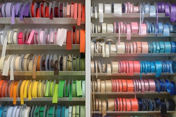 multicolored ribbons for sewing on the shelf