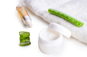aloe cosmetic cream face, skin and body care with towel on white background
