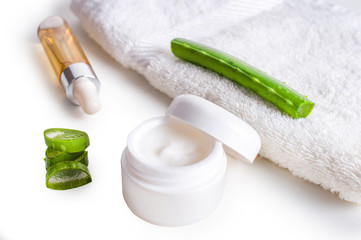 aloe cosmetic cream face, skin and body care with towel on white background
